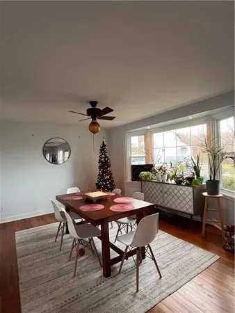 a dining room with furniture and wooden floor