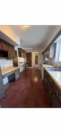 a living room with furniture and a kitchen