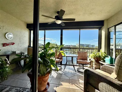 a living room with furniture and floor to ceiling window