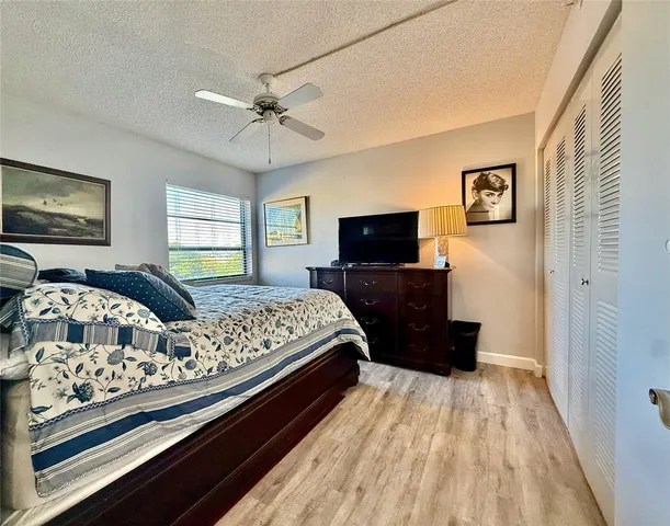 a bed room with a bed mirror and window