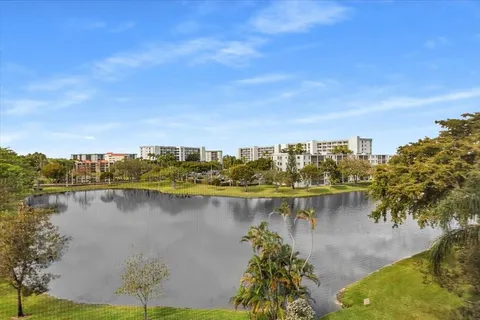 an empty room with wooden floor closet and windows