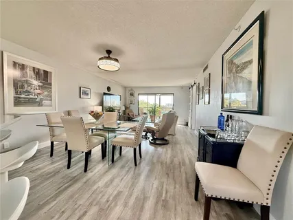 a living room with furniture wooden floor and a window