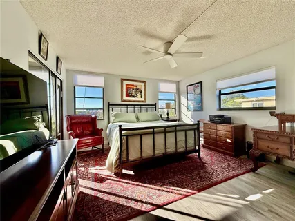 a living room with furniture a flat screen tv and a couch