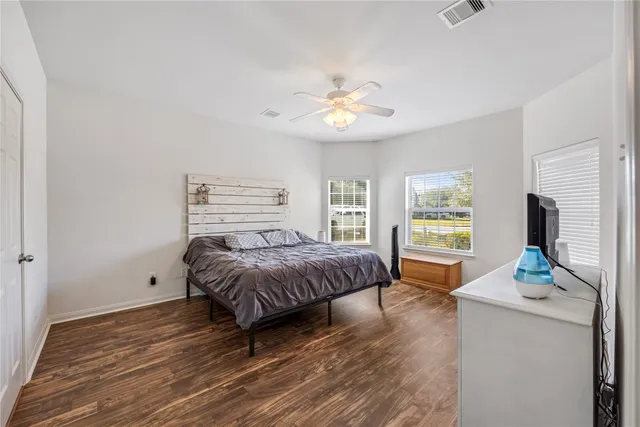 a spacious bedroom with a bed and a chandelier
