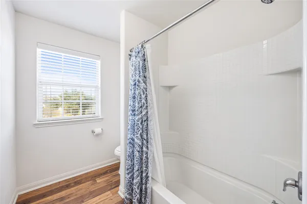 a bathroom with a bathtub and shower