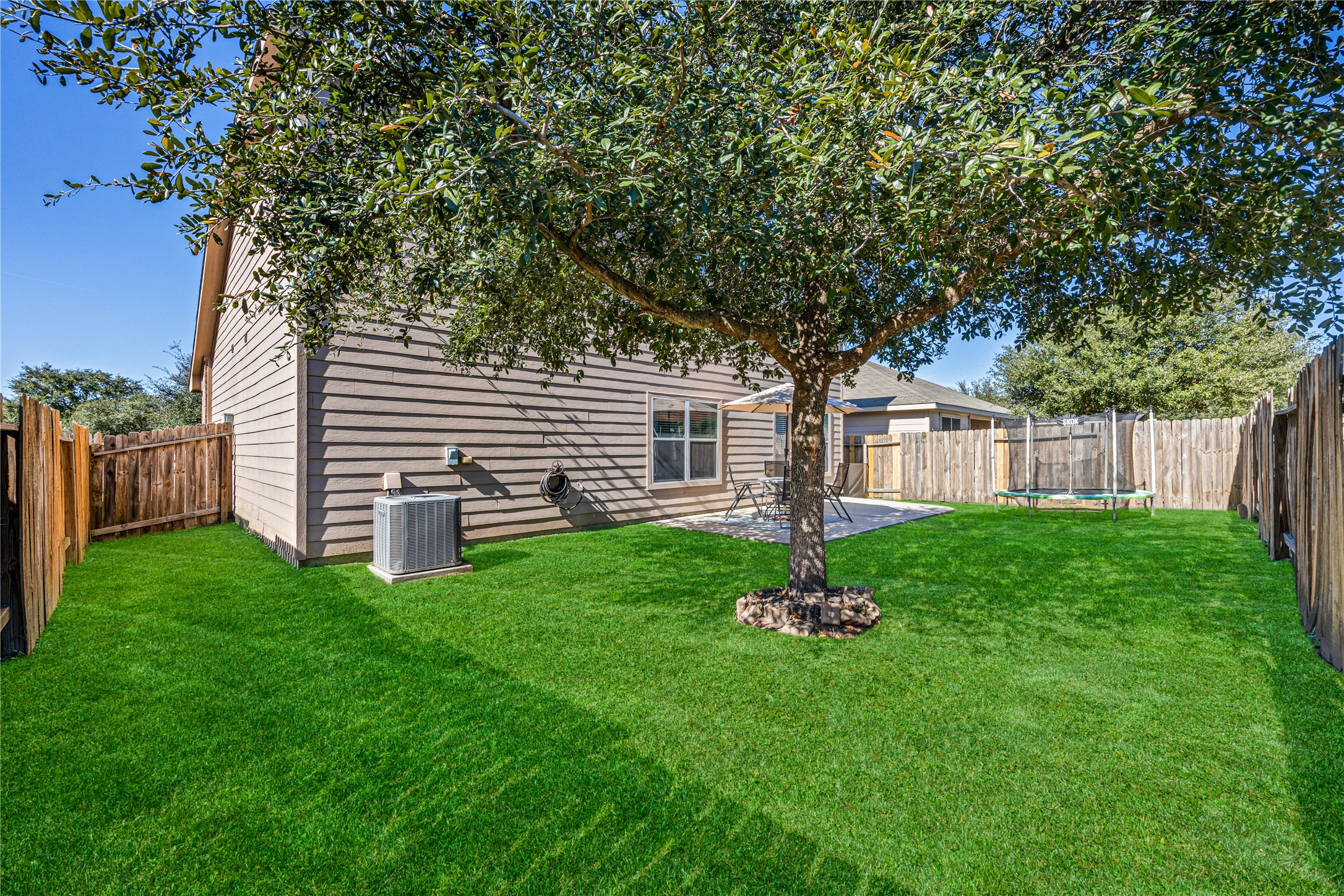 319 Falling Pine Drive Conroe, TX 77304 - Photo 21 of 22 a backyard of a house with table and chairs