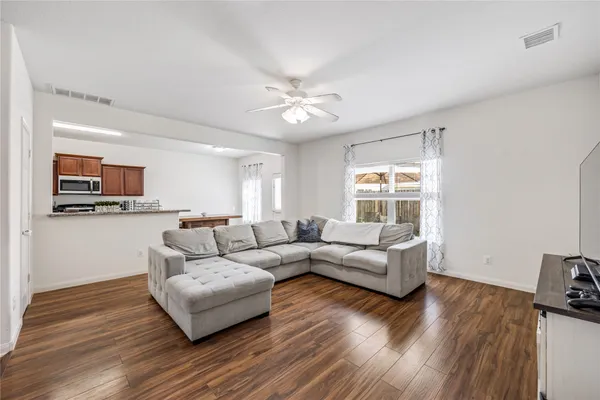 a living room with furniture and wooden floor