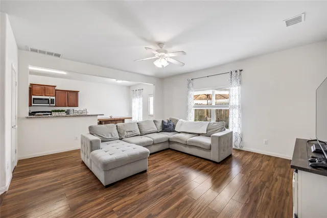 a living room with furniture and wooden floor
