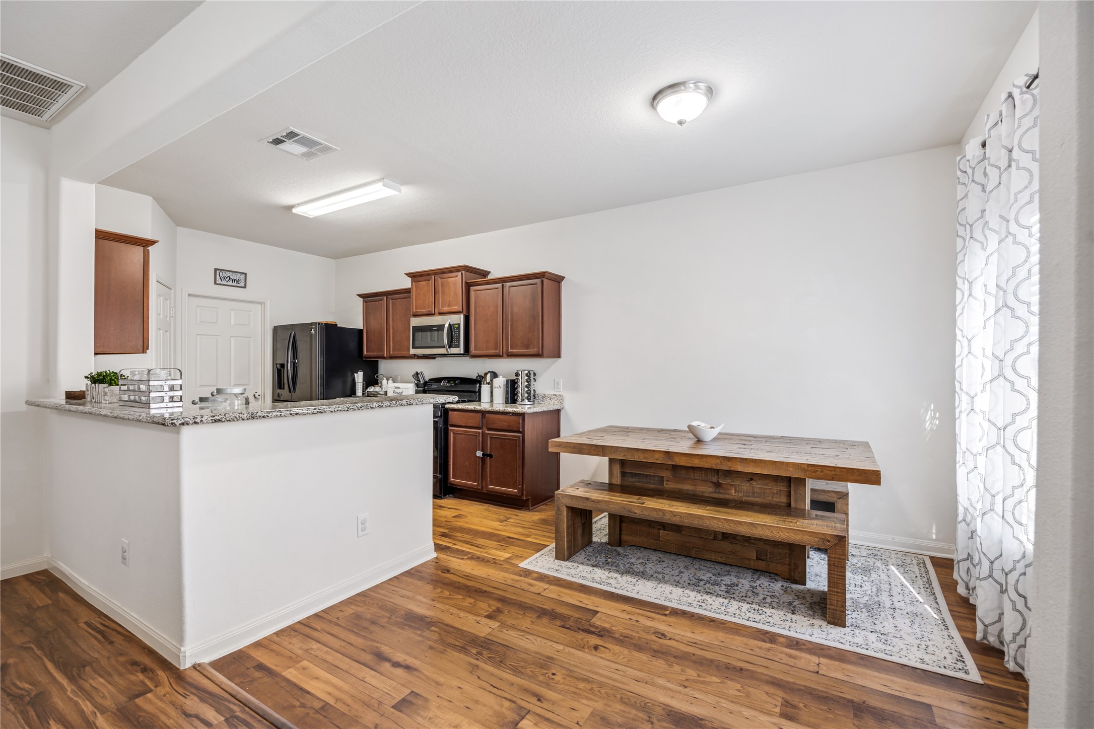 319 Falling Pine Drive Conroe, TX 77304 - Photo 6 of 22 a kitchen with sink refrigerator and microwave