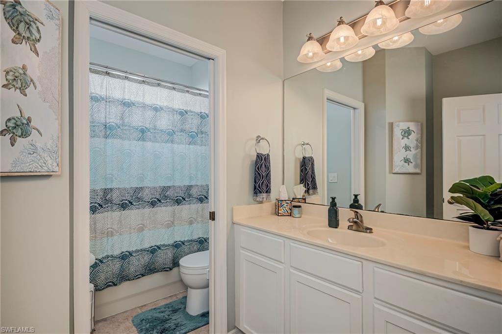 1897 Par Drive Naples, FL 34120 - Photo 15 of 31 a bathroom with a double vanity sink mirror and toilet