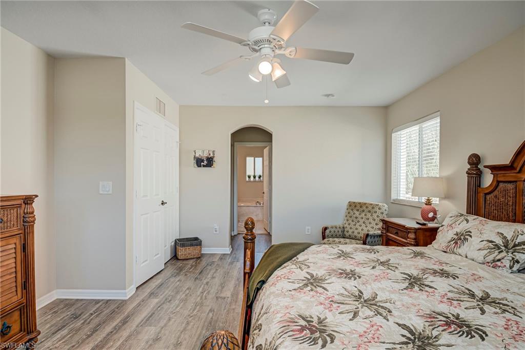 1897 Par Drive Naples, FL 34120 - Photo 17 of 31 a bedroom with a bed and a chandelier