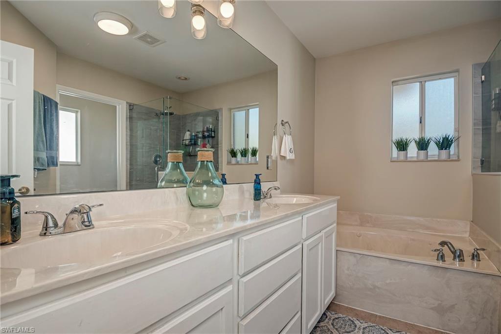 1897 Par Drive Naples, FL 34120 - Photo 18 of 31 a bathroom with a tub sink and mirror