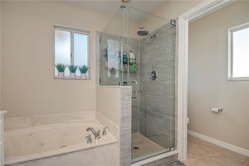 1897 Par Drive Naples, FL 34120 - Photo 19 of 31 a bathroom with a bathtub and a shower