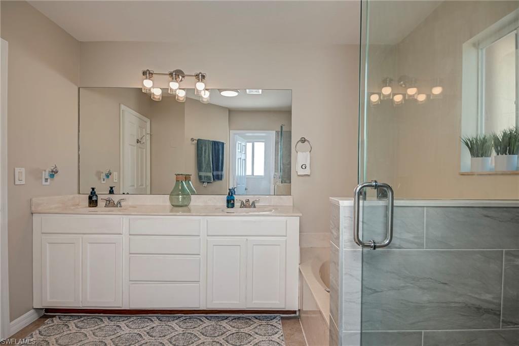 1897 Par Drive Naples, FL 34120 - Photo 20 of 31 a bathroom with a double vanity sink mirror and shower