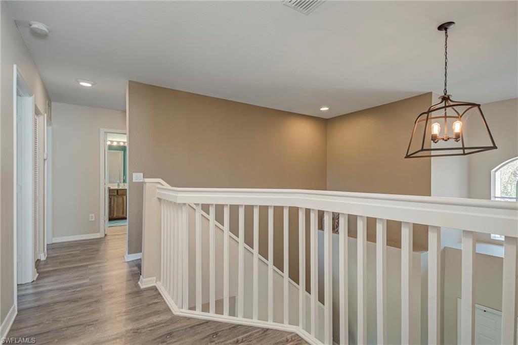 1897 Par Drive Naples, FL 34120 - Photo 21 of 31 a view of a hallway with wooden floor