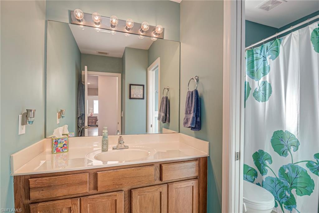 1897 Par Drive Naples, FL 34120 - Photo 24 of 31 a bathroom with a sink and a mirror