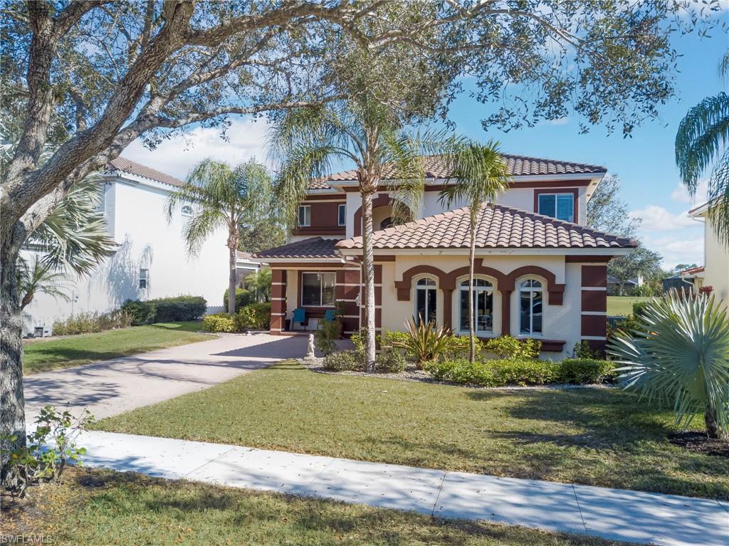 1897 Par Drive Naples, FL 34120 - Photo 28 of 31 a front view of house with yard and green space