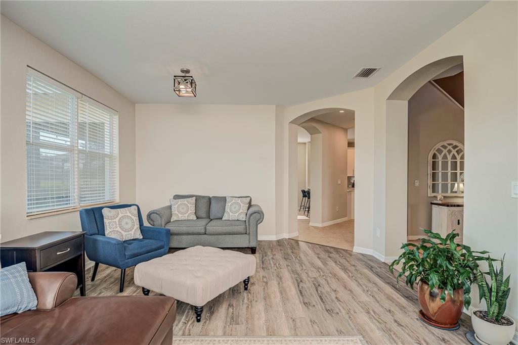 1897 Par Drive Naples, FL 34120 - Photo 5 of 31 a living room with furniture and a potted plant