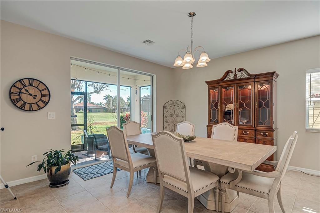 1897 Par Drive Naples, FL 34120 - Photo 6 of 31 a dining room with furniture a chandelier and window