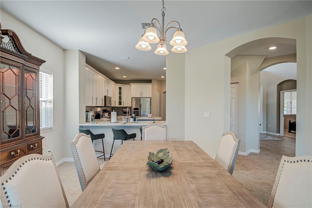 1897 Par Drive Naples, FL 34120 - Photo 8 of 31 a living room with furniture a flat screen tv and kitchen view