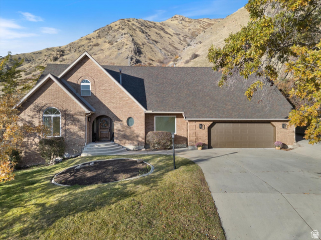 2078 Spring Oaks Drive Springville, UT 84663 - Photo 1 of 40 View of front of home featuring brick siding, concrete driveway, a mountain view, and an attached garage