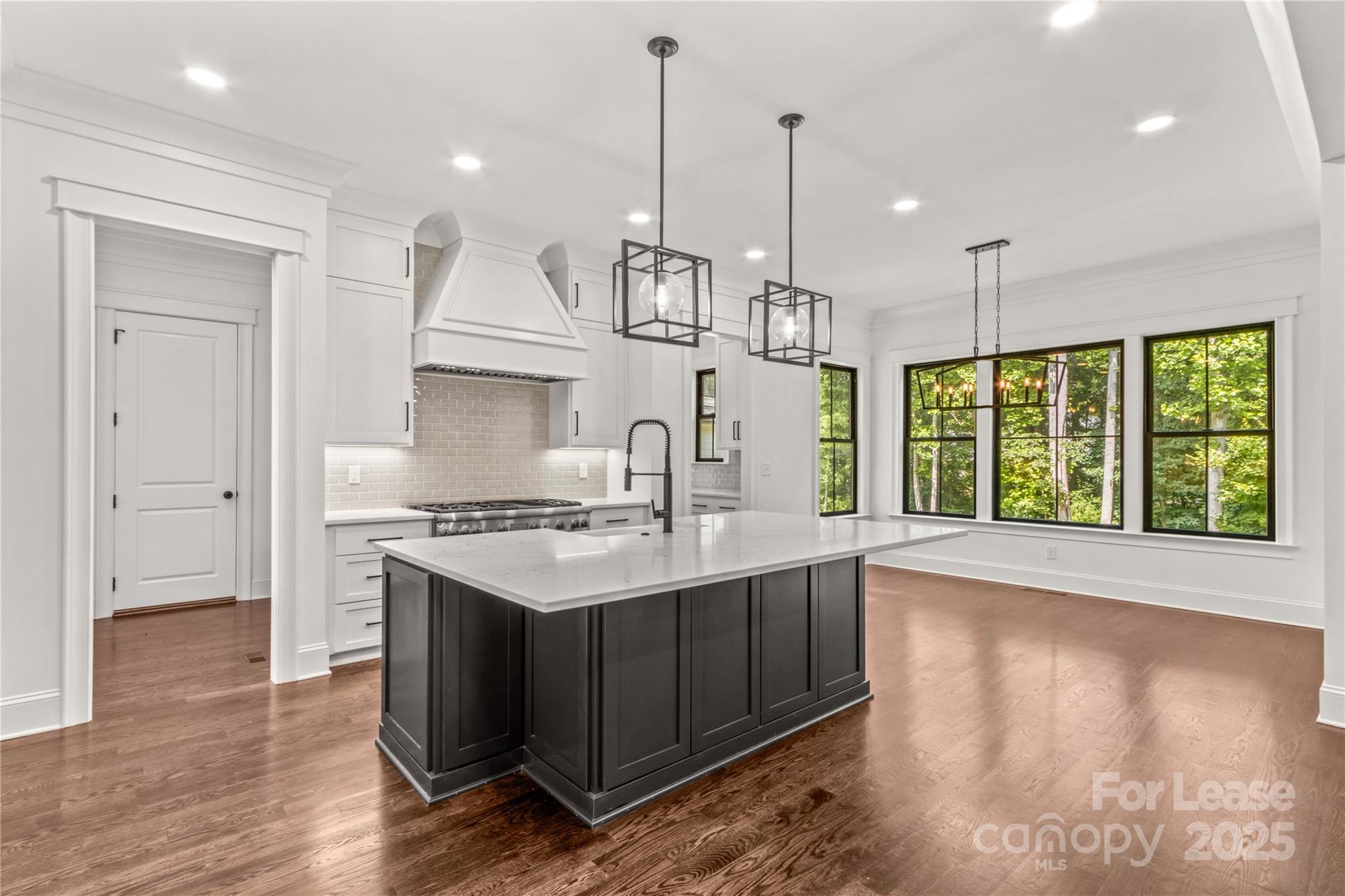 269 Conroy Avenue Davidson, NC 28036 - Photo 23 of 48 a kitchen with a stove and a wooden floor