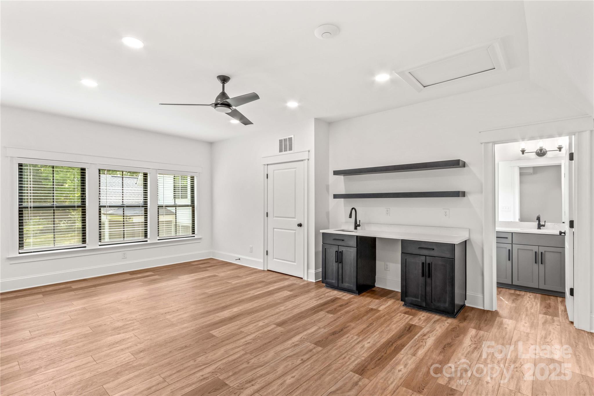 269 Conroy Avenue Davidson, NC 28036 - Photo 41 of 48 a view of an empty room with a kitchen and a fireplace