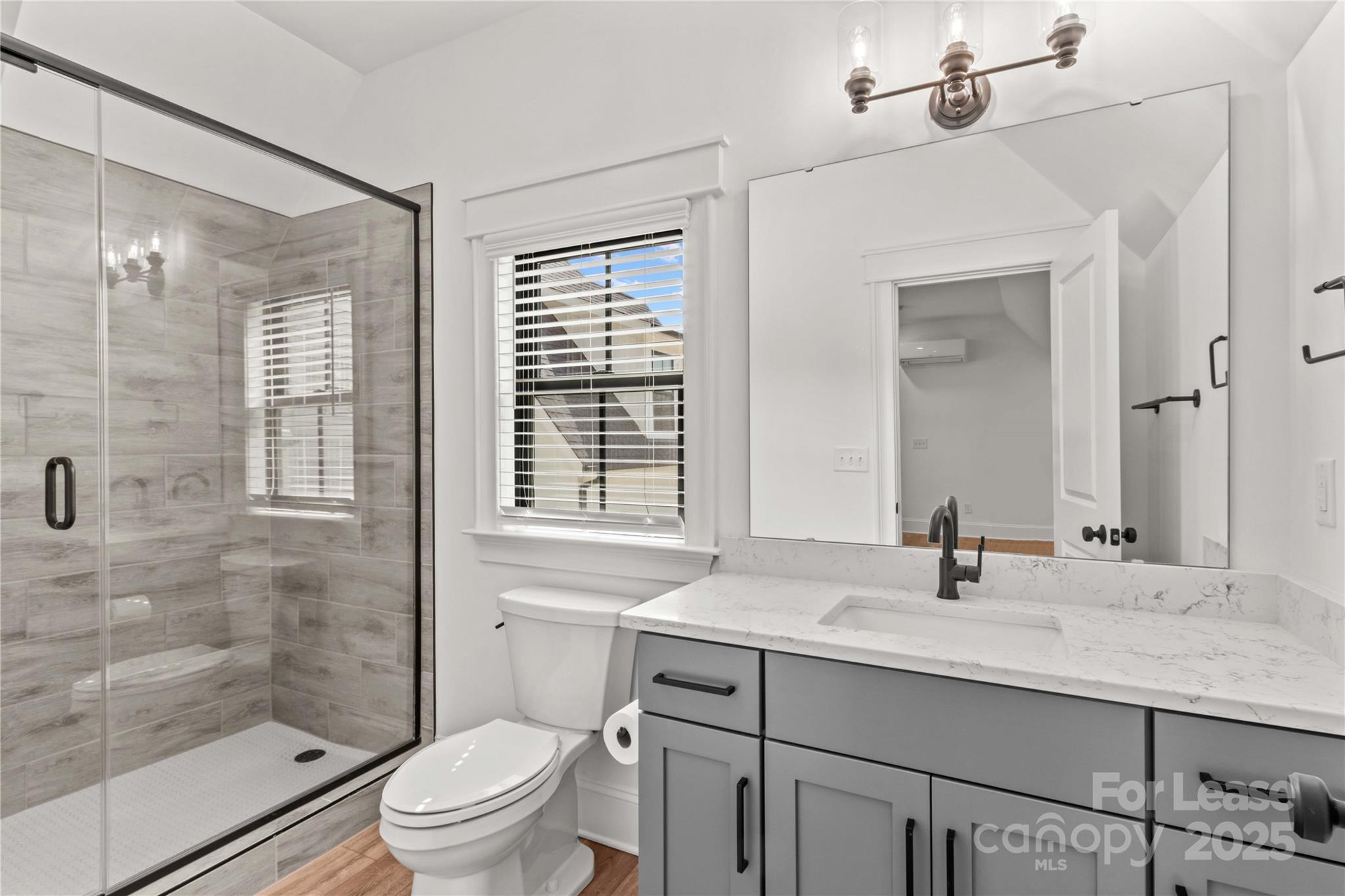 269 Conroy Avenue Davidson, NC 28036 - Photo 42 of 48 a bathroom with a sink toilet a mirror and shower
