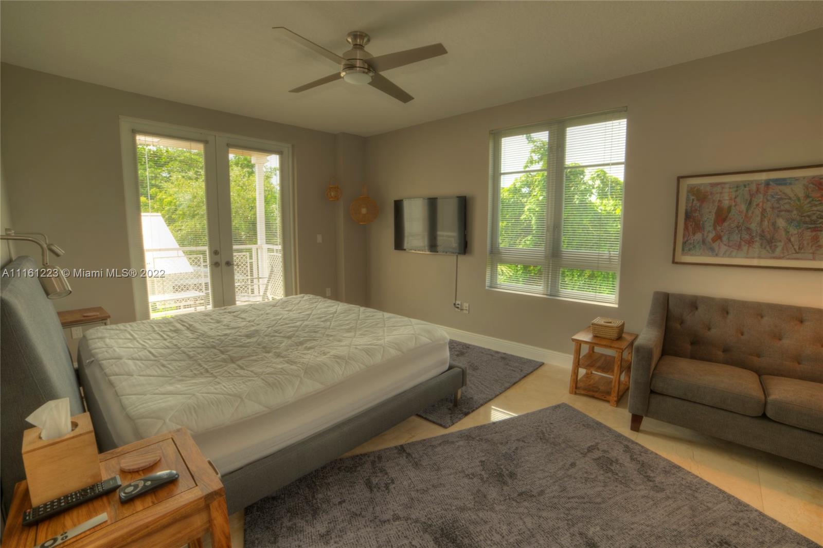 3540 Main Highway, Unit 305 Miami, FL 33133 - Photo 3 of 14 a bedroom with a bed window and couch