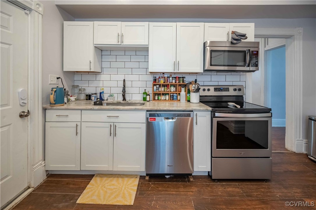 5 West Graham Road Richmond, VA 23222 - Photo 19 of 42 a kitchen with white cabinets and appliances