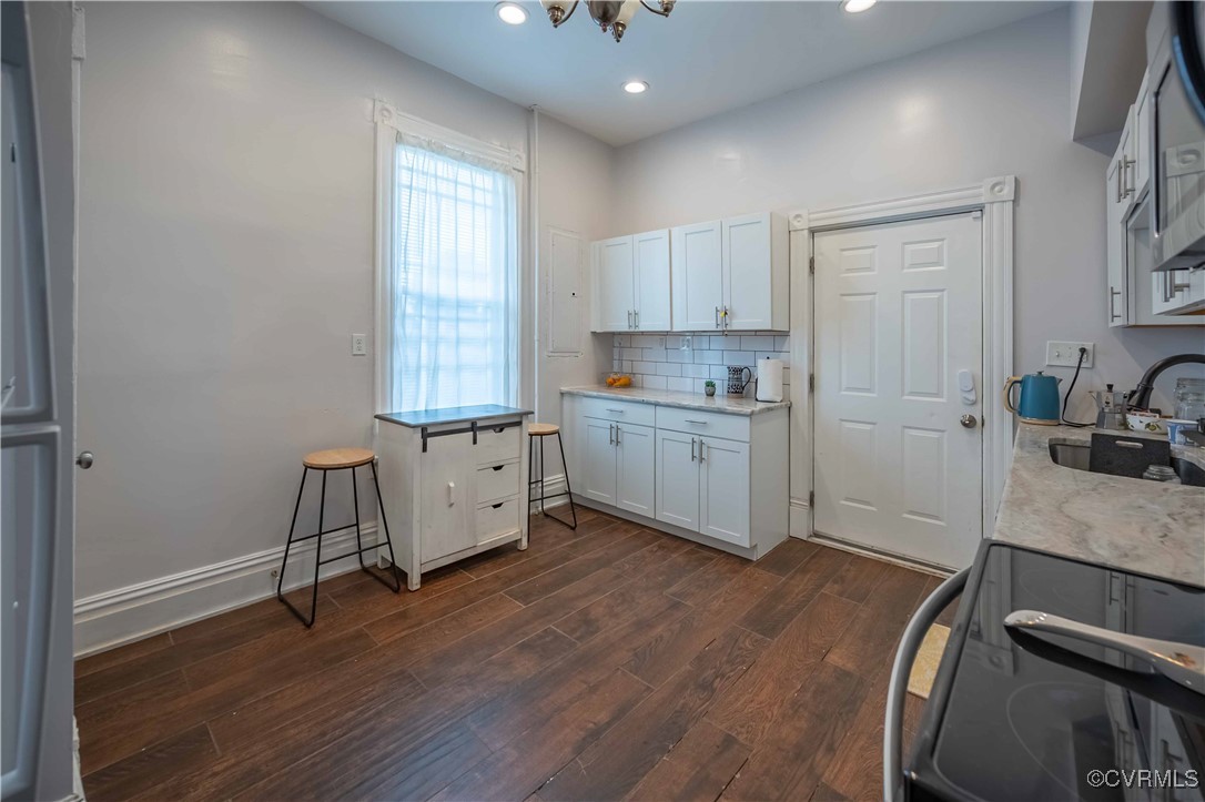5 West Graham Road Richmond, VA 23222 - Photo 21 of 42 a kitchen with a sink appliances cabinets and a window
