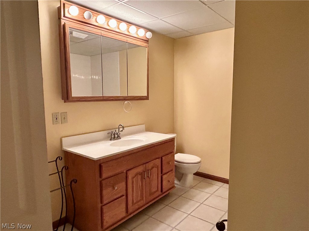 40 East Western Reserve Road, Unit 1 Youngstown, OH 44514 - Photo 19 of 33 Bathroom featuring toilet, vanity, a drop ceiling, and tile flooring