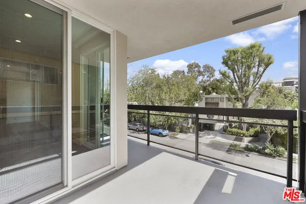 a spacious bedroom with a bed and wooden floor