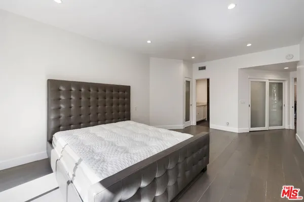 a bathroom with a shower sink large mirror and shower