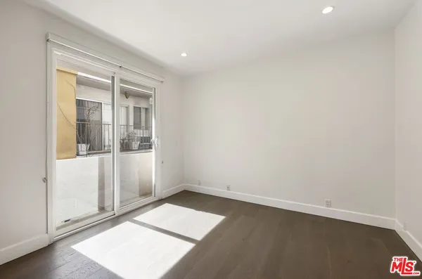 a living room with furniture and a large window with garden view