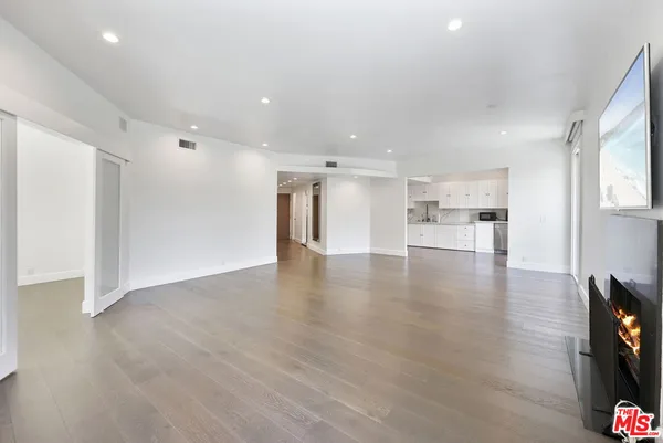 a kitchen with stainless steel appliances granite countertop a refrigerator sink and white cabinets