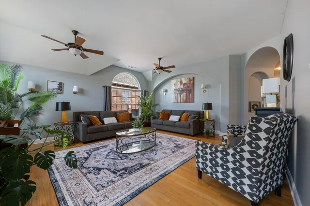 a living room with furniture rug and a chandelier