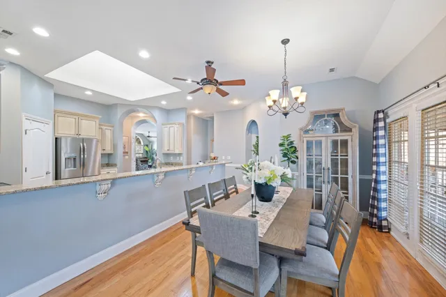 a view of a dining room with furniture and a chandelier