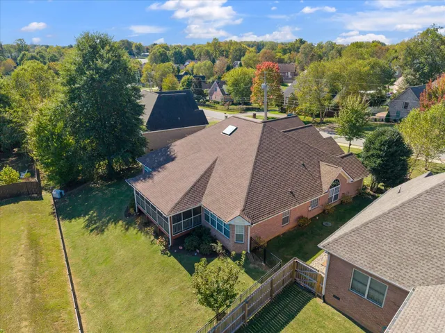 an aerial view of a house with swimming pool and mountains