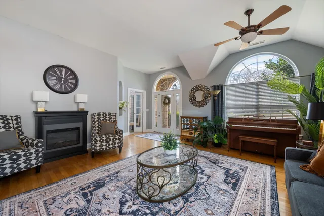 a living room with furniture a clock and a rug