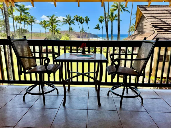 a view of a chairs and table in the balcony