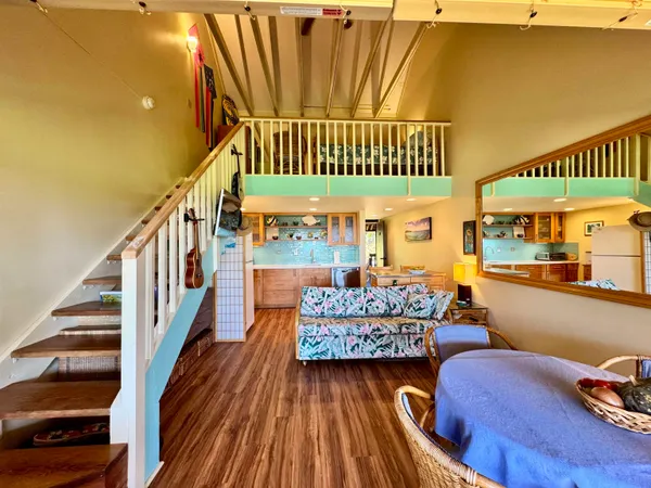 a view of entryway livingroom and hall with wooden floor