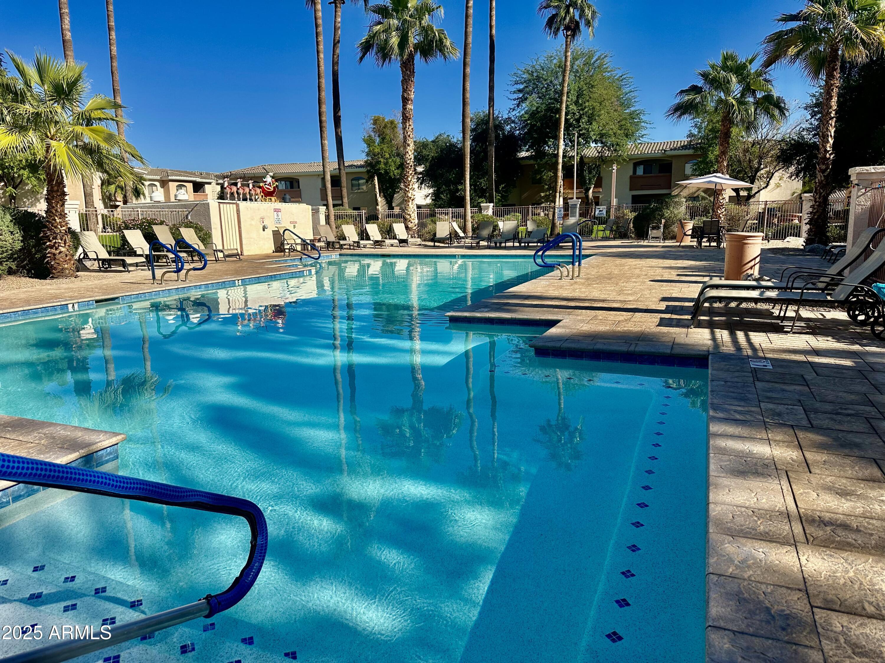 10030 West Indian School Road, Unit 227 Phoenix, AZ 85037 - Photo 1 of 22 a view of swimming pool with a patio