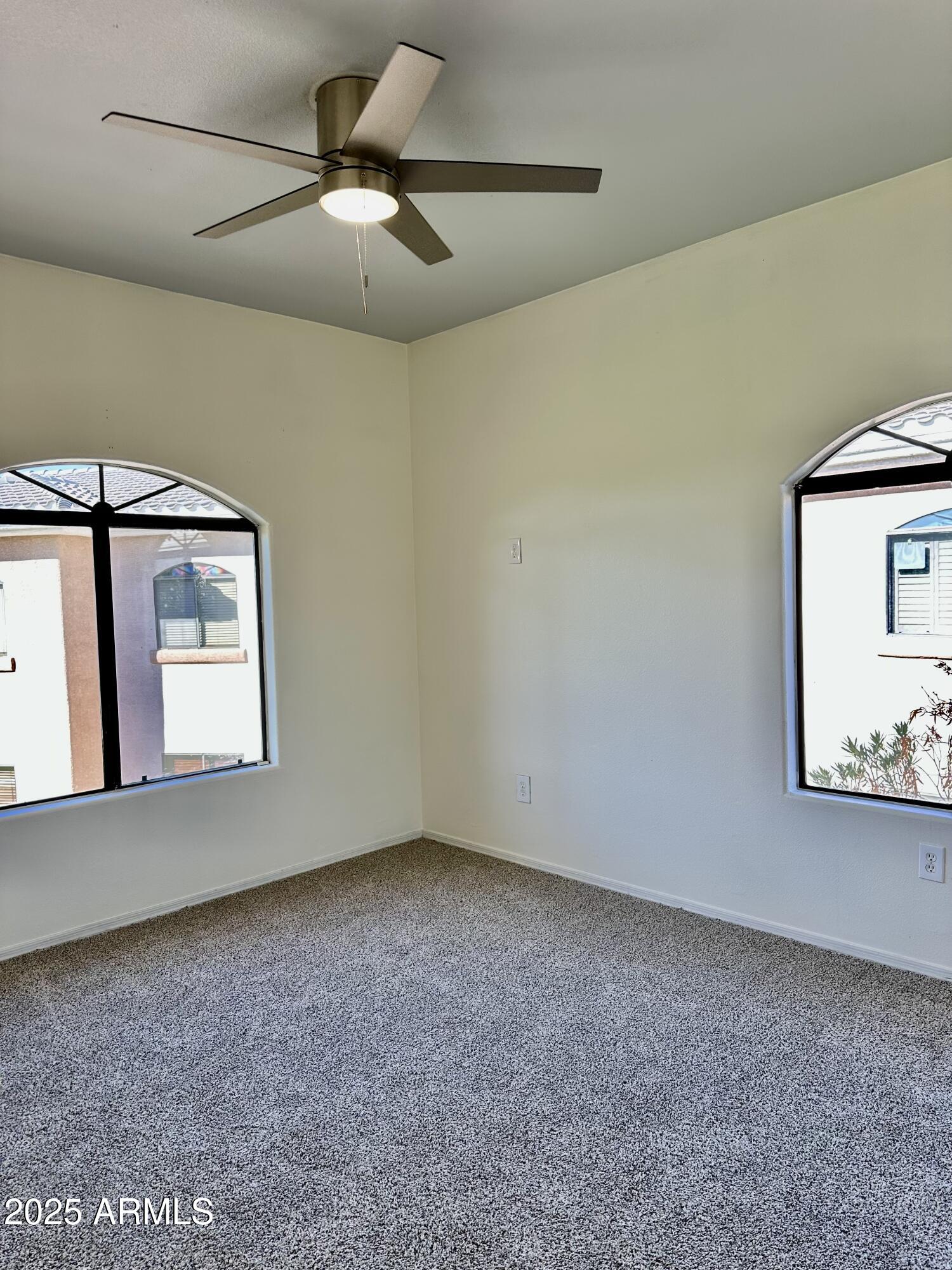 10030 West Indian School Road, Unit 227 Phoenix, AZ 85037 - Photo 12 of 22 a view of an empty room with a window