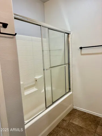a bathroom with a glass shower door