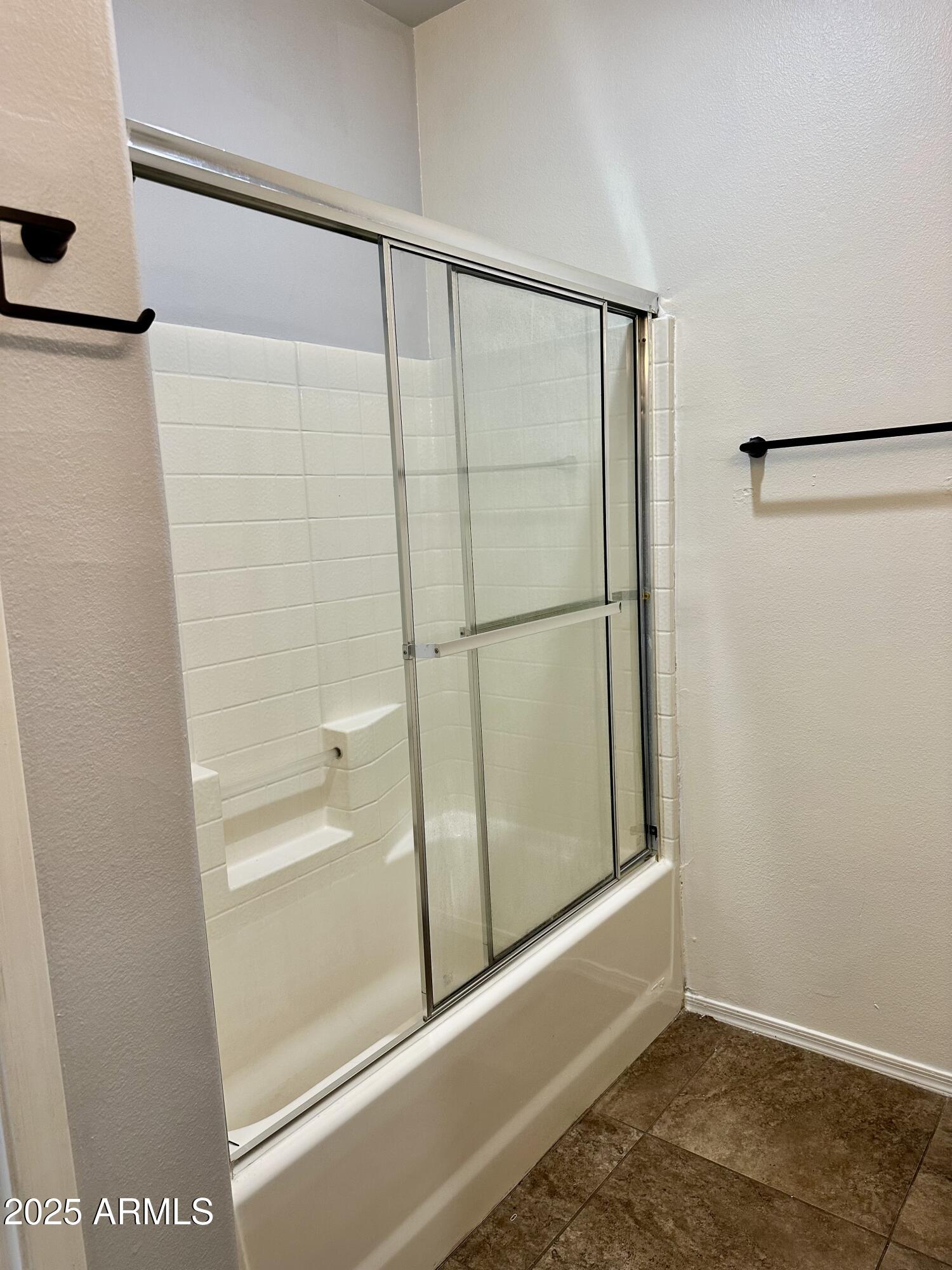 10030 West Indian School Road, Unit 227 Phoenix, AZ 85037 - Photo 14 of 22 a bathroom with a glass shower door