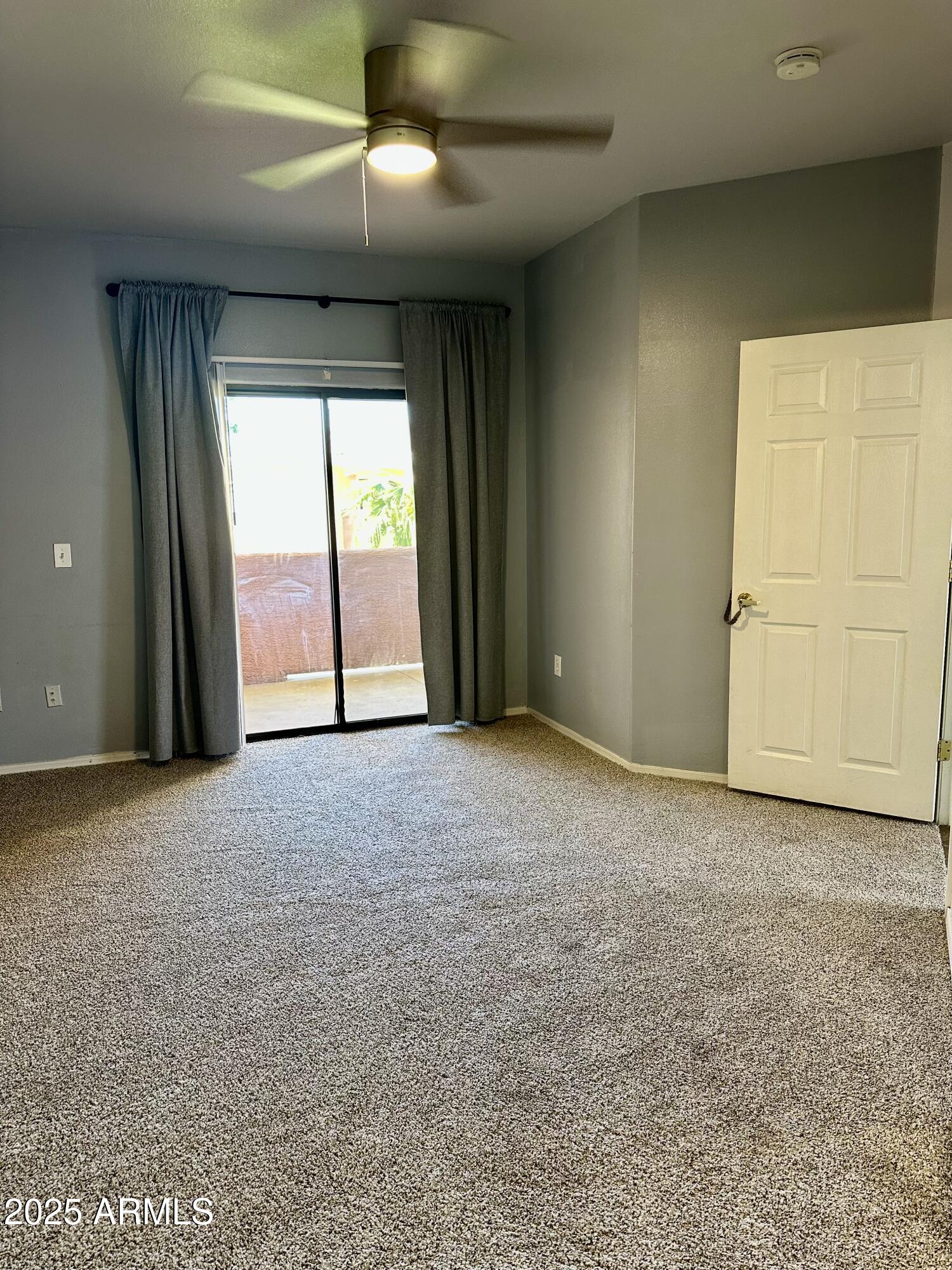10030 West Indian School Road, Unit 227 Phoenix, AZ 85037 - Photo 17 of 22 a view of an empty room with a window