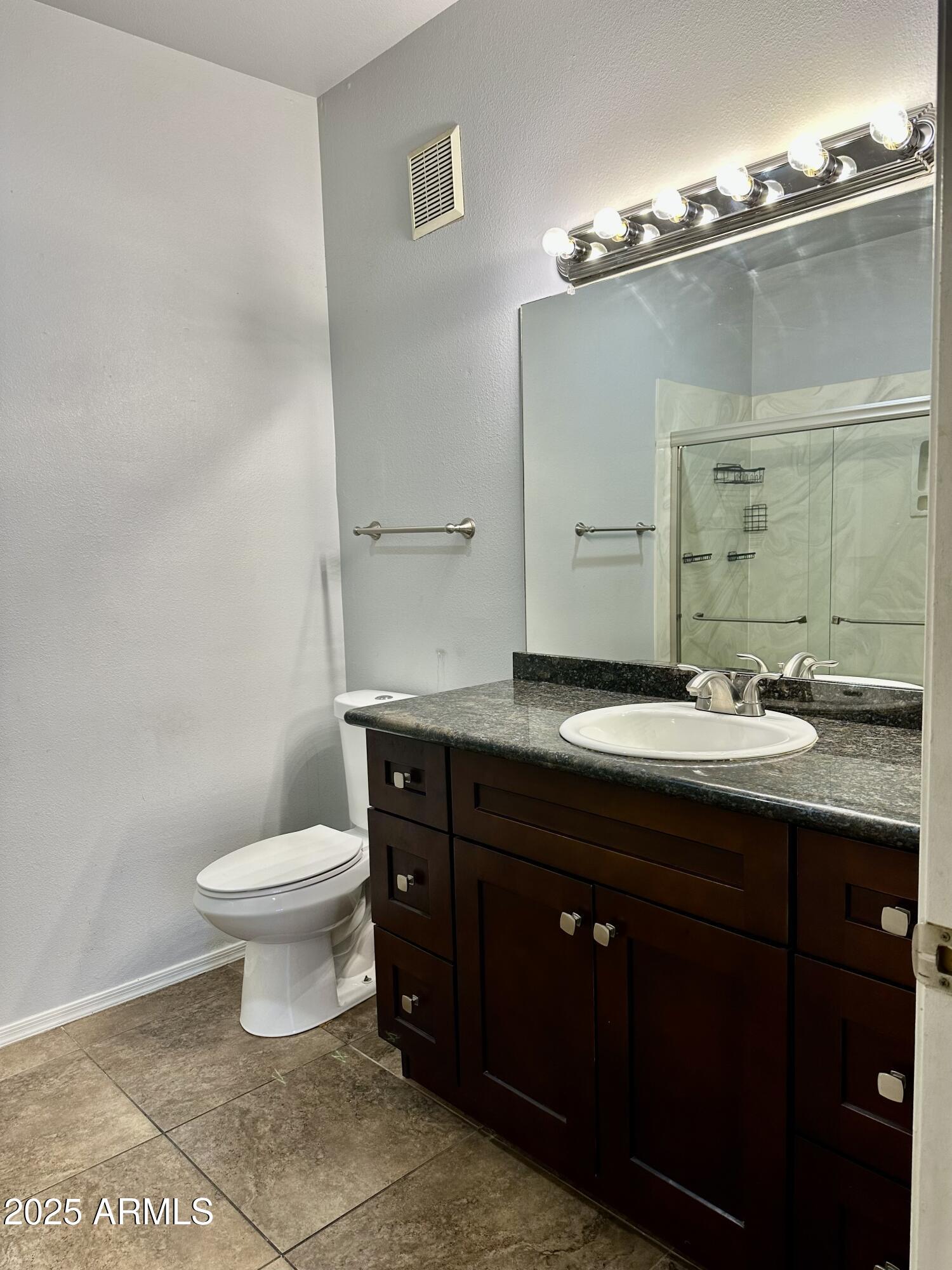 10030 West Indian School Road, Unit 227 Phoenix, AZ 85037 - Photo 19 of 22 a bathroom with a sink and a toilet