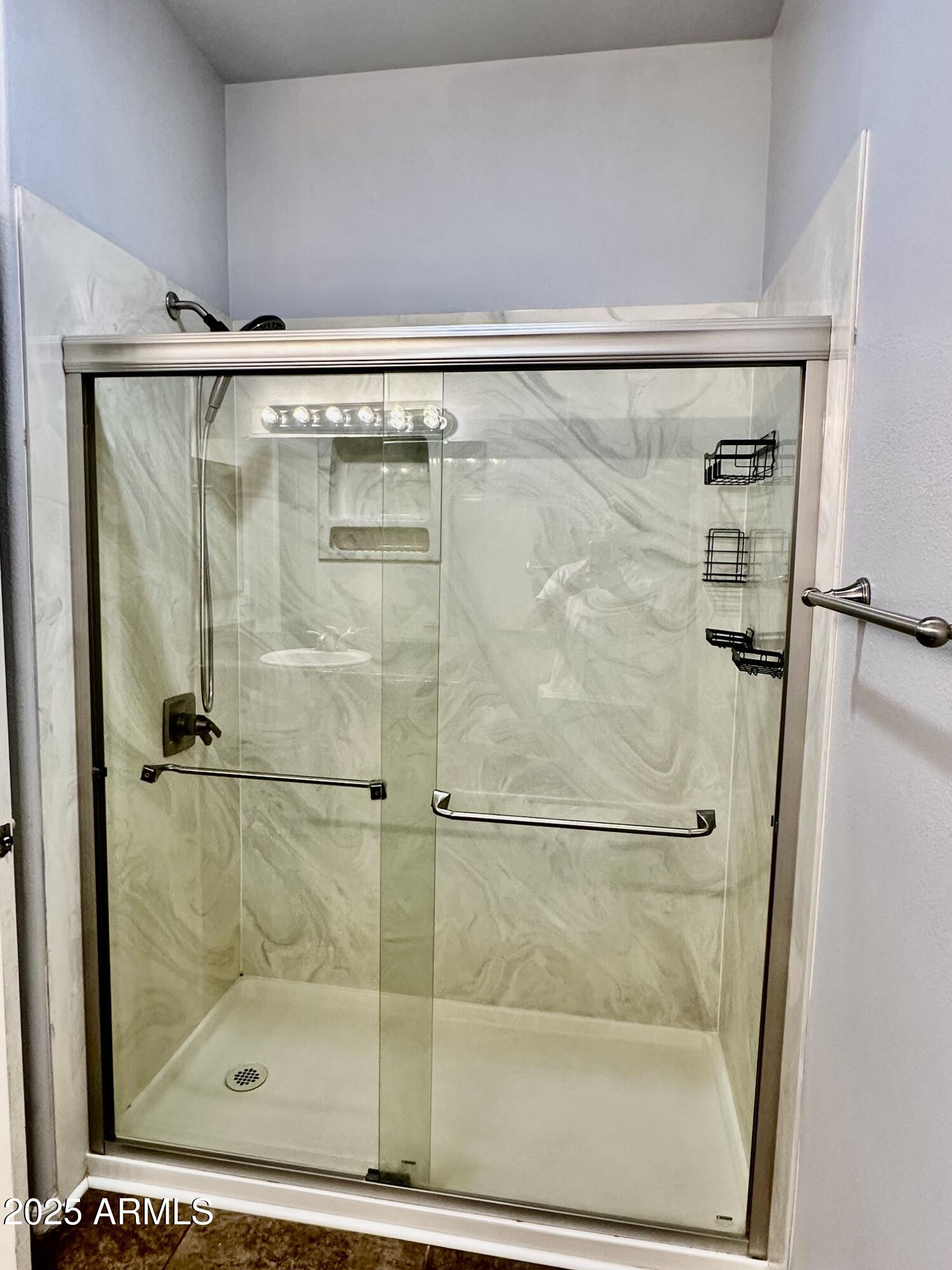 10030 West Indian School Road, Unit 227 Phoenix, AZ 85037 - Photo 20 of 22 a bathroom with a glass shower door