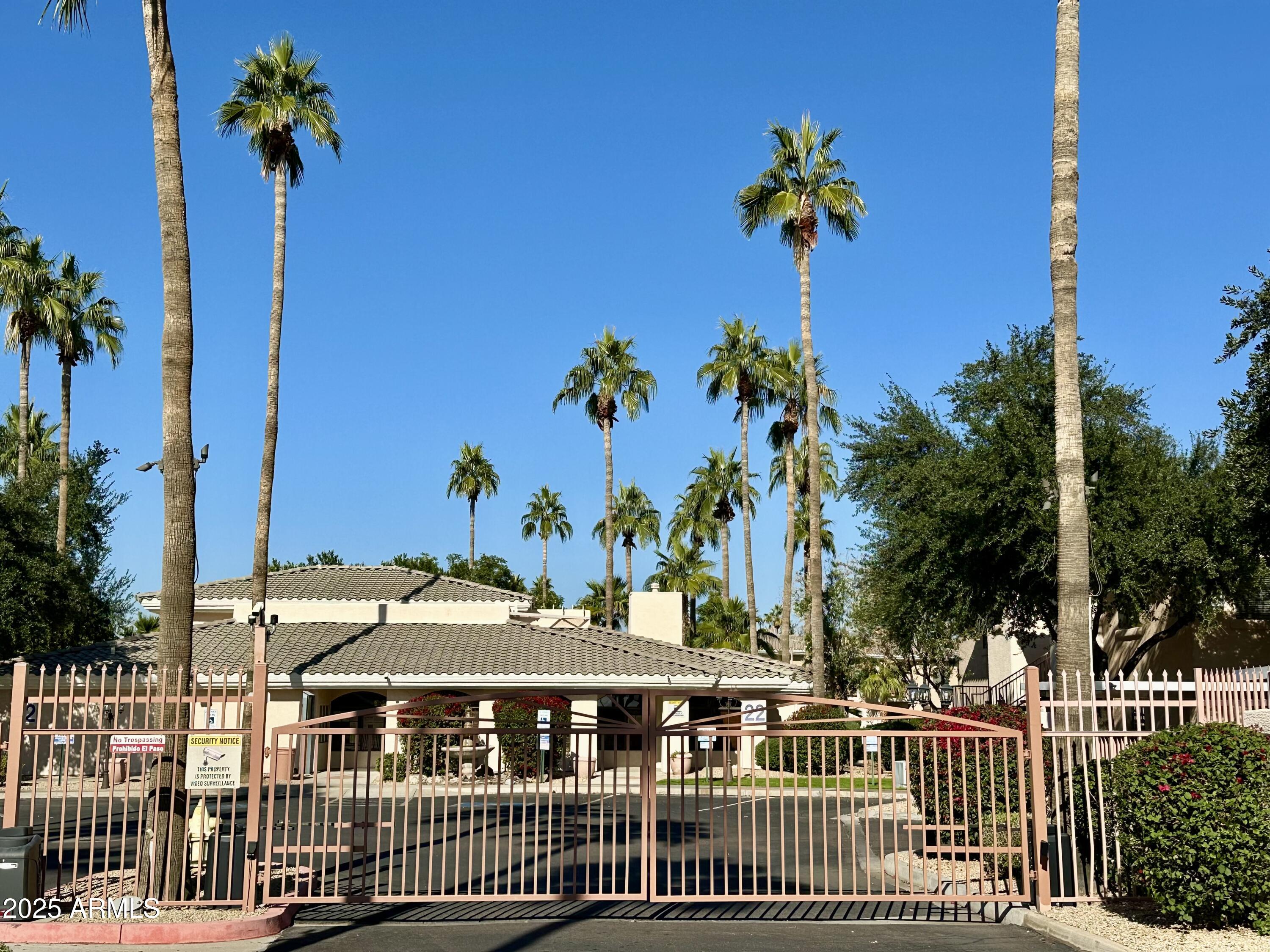10030 West Indian School Road, Unit 227 Phoenix, AZ 85037 - Photo 21 of 22 a view of a house with a flower garden